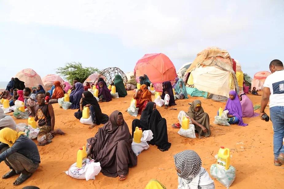 One Ummah Foundation volunteers providing essential food aid to families in need in Barawa, Somalia